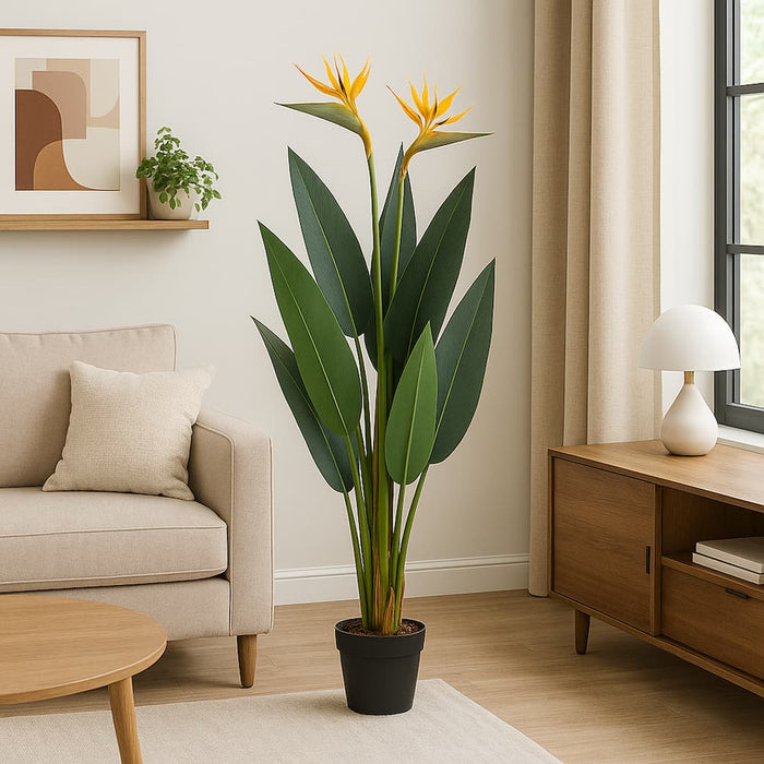 Living room with a large potted plant, beige sofa, wooden coffee table, and sideboard.